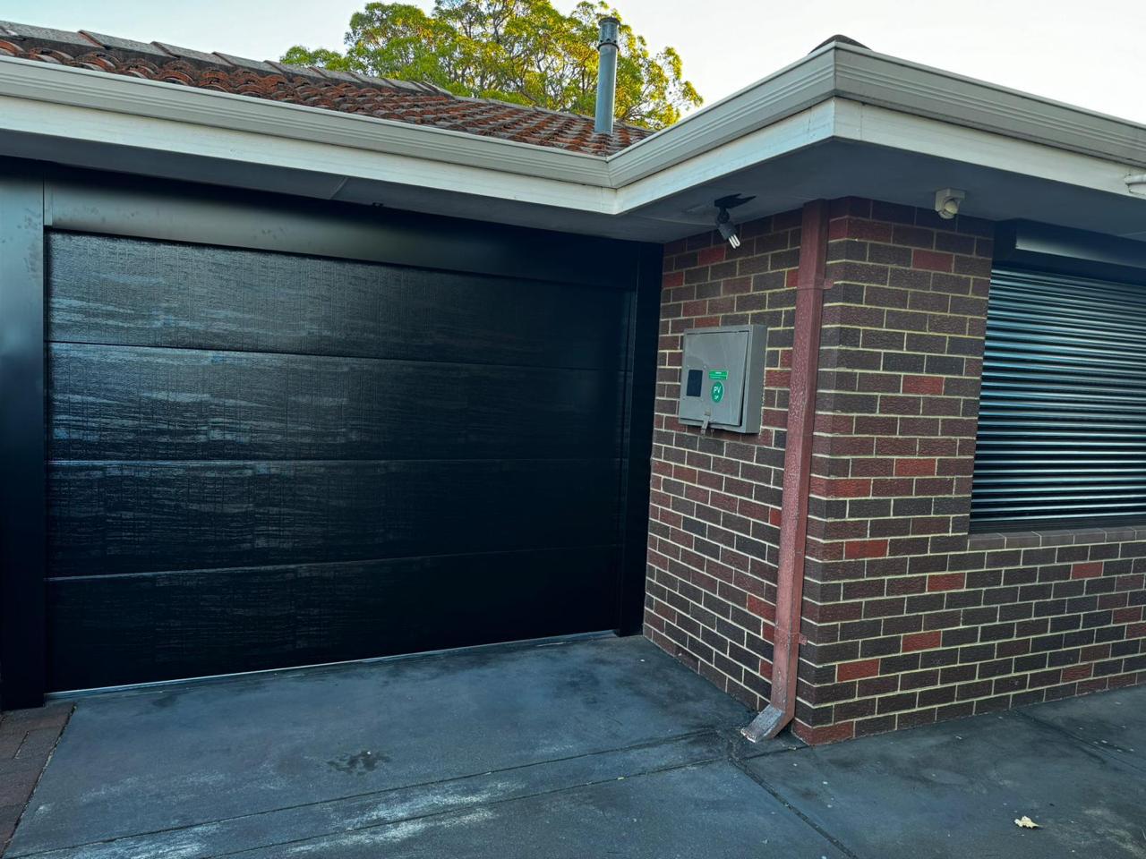 New residential garage door installation - modern sectional door